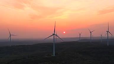 4K航拍山脉风力发电风轮机日落美景视频的预览图